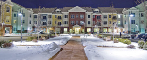 Night view of Village at Taylor Pond main entrance in winter